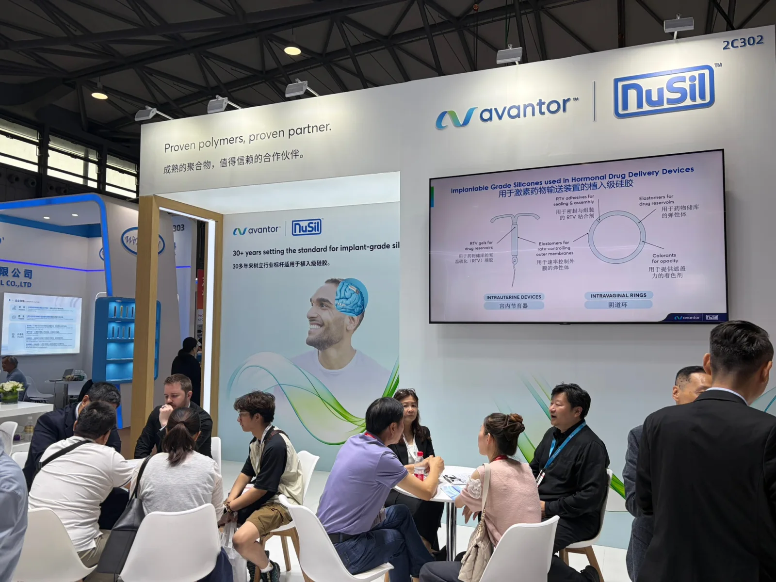 Visitors seated at the Avantor NuSil exhibit beneath a medical-silicone application display during Medtec China 2026